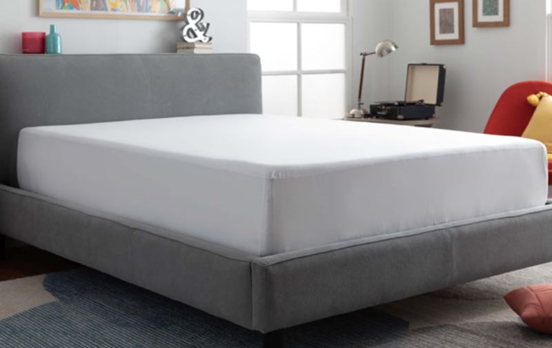 Mattress covered in white sheet with grey fabric frame.