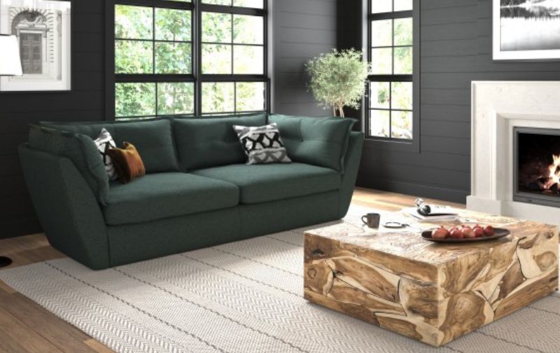Bottle green sofa with wooden block coffee table.