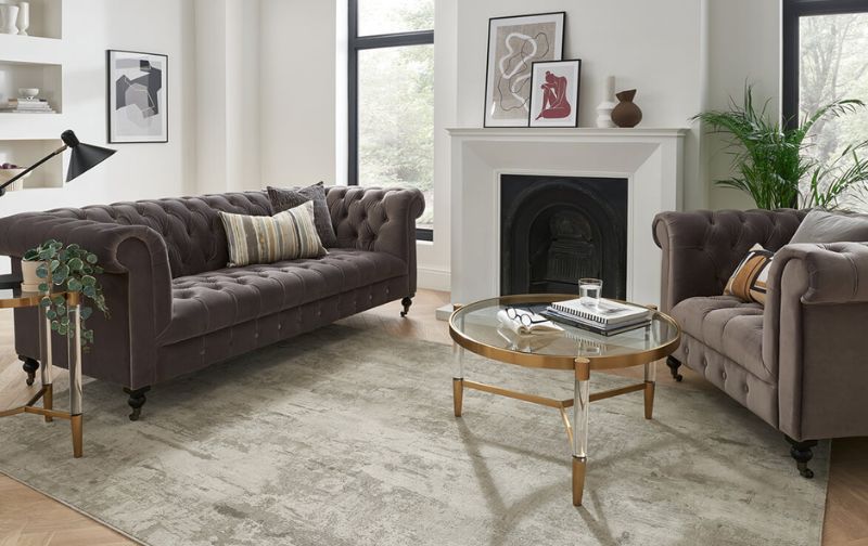 Light brown and beige velvet sofas with neutral coloured rug.