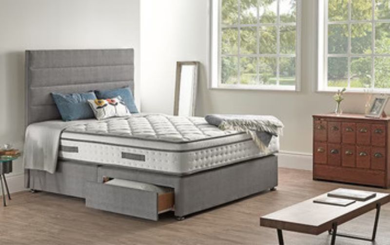 Grey fabric divan bed with storage.