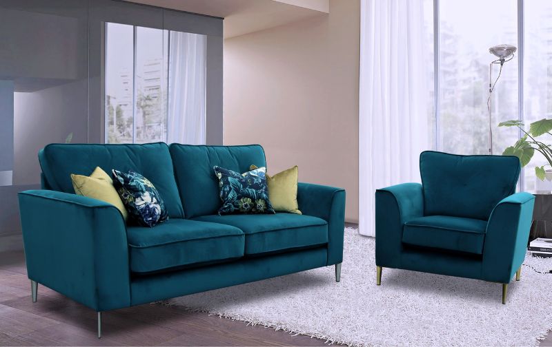 Green velvet sofa with silver legs and matching armchair.