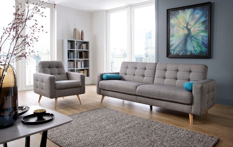 Light grey tufted Scandi sofas with matching neutral rug.