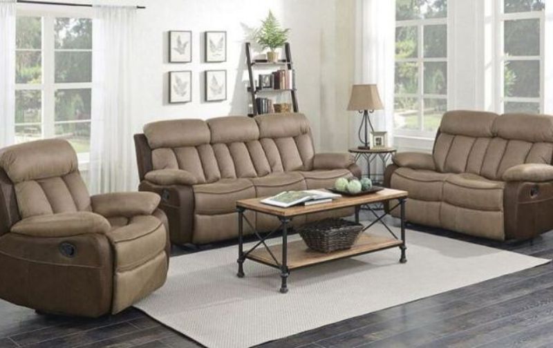 Brown leather three seater sofa, two seater sofa and matching chair with cream rug.