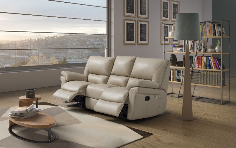 Faux leather three seater cream reclining sofa with matching rug.