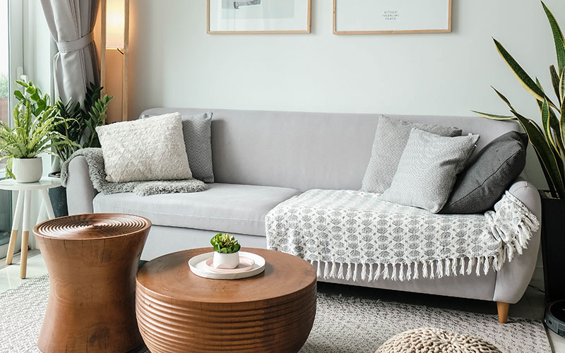 Grey fabric minimalist sofa with wooden legs.