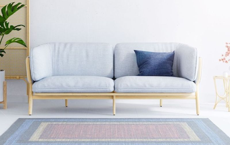 Contemporary light grey loveseat with wooden legs.