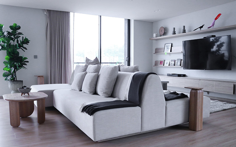 Grey linen back to back sofas in large living room.