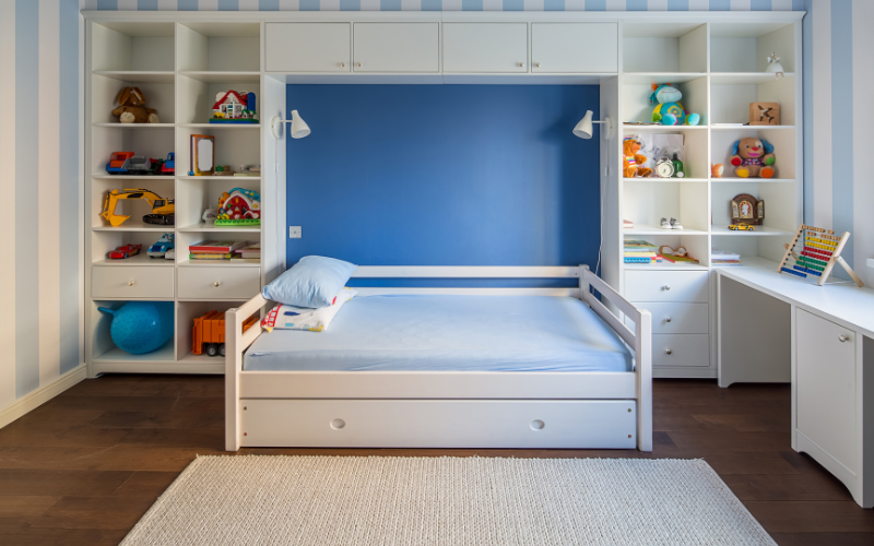 an mdf bed in a room with shelves and toys