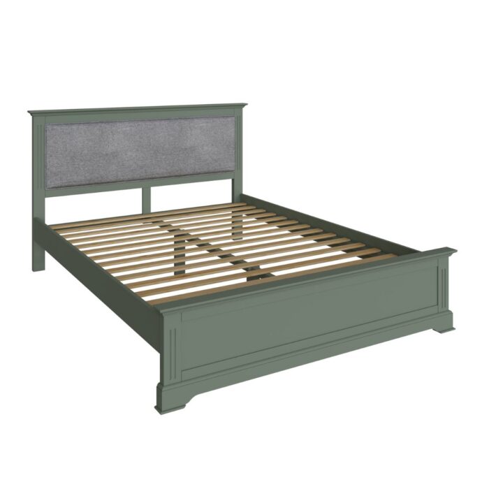 green bed with upholstered headboard