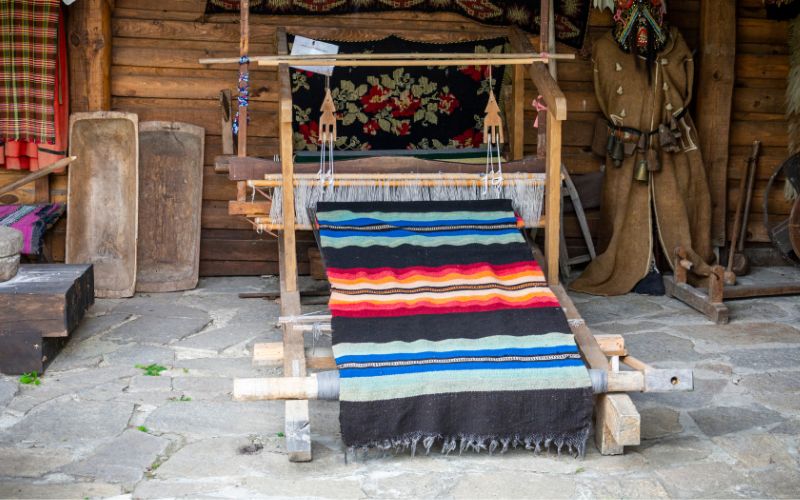 a rug loom depicting ancient rug weaving