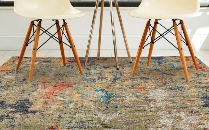 a group of chairs on an abstract rug