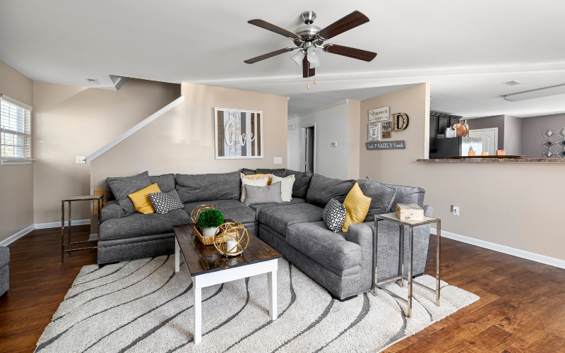 a living room with a an area rug, couch and a table