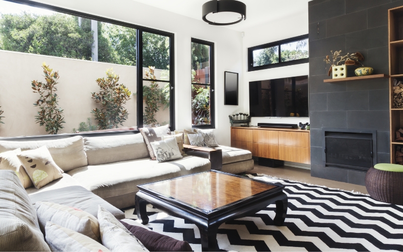 a living room with a black and white striped chevron rug and a couch