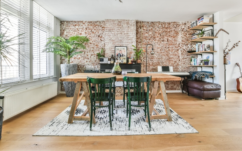 a dining room with a table and chairs on a rug