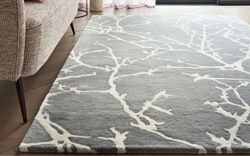 a hand tufted rug on the floor