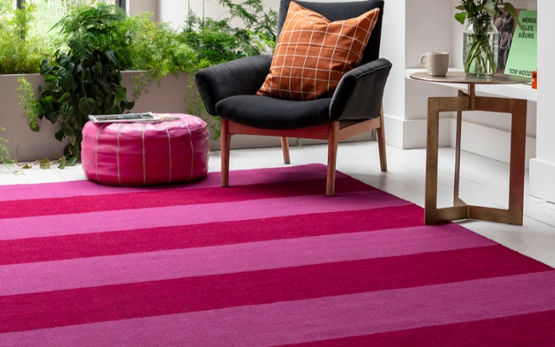 a chair and a hot pink rug colour