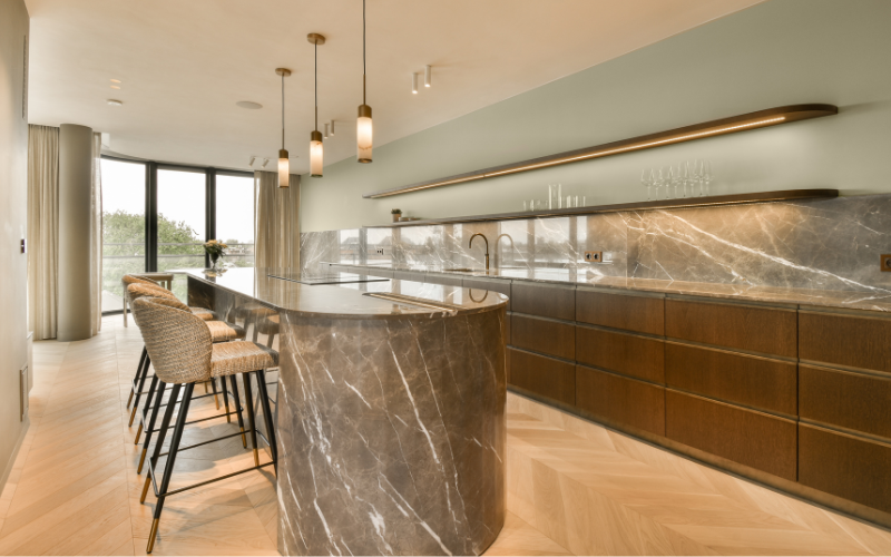 a kitchen with a marble bar and chairs