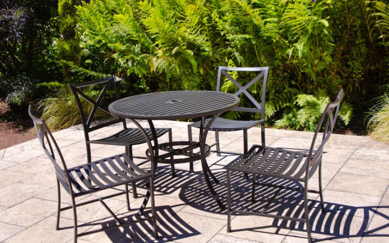 a metal table and chairs on a patio