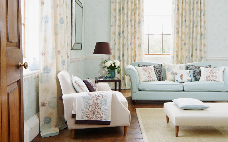 a living room with a couch and a lamp on a cream coloured rug