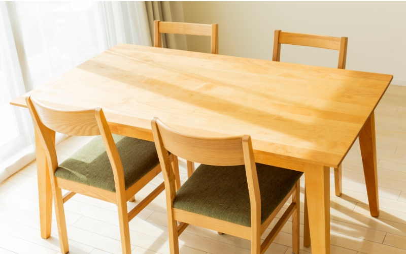 an oak table and chairs in a room