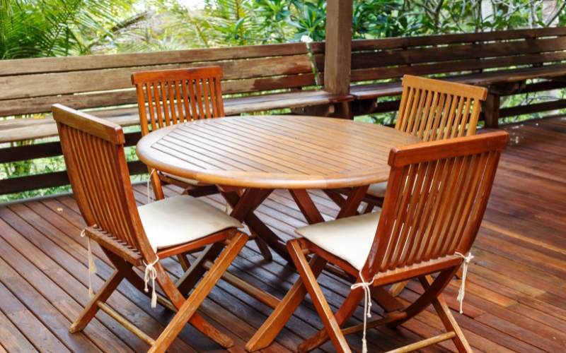 outdoor furniture wooden table and chairs on a deck