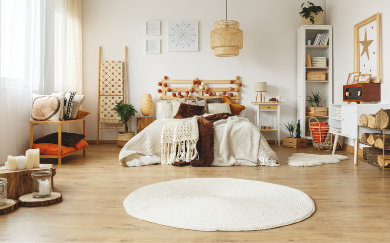 a bedroom with a white round rug and a bed