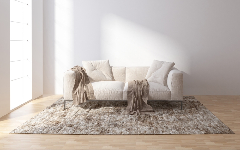 a couch with blankets on a 120x180 cm rug