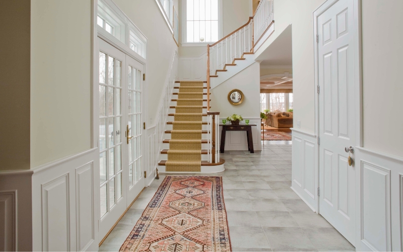 a staircase in a house with a long runner rug