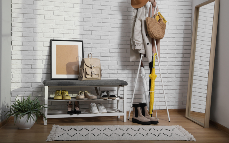 a shoe rack with shoes and a hat on it