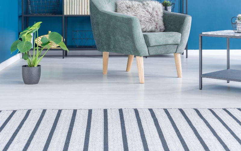 a chair in a room with stripey rug