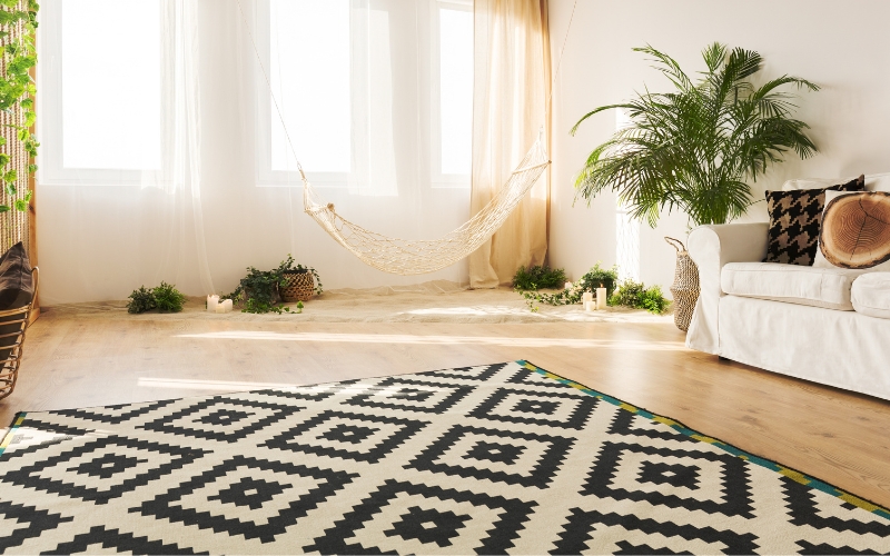 a hammock in a room with abstract rug