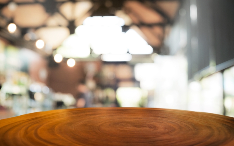 a wooden table crafted from walnut with a blurry background