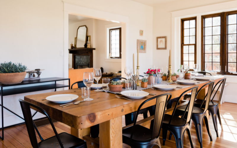 a wooden table with plates and glasses on it